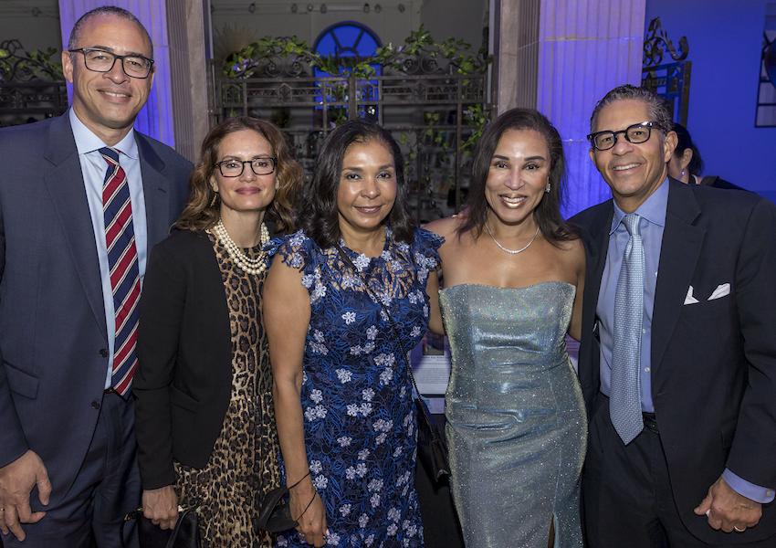 five attendees of the gala smiling for the camera, with Michael Heningburg, one of the honorees, at far right.
