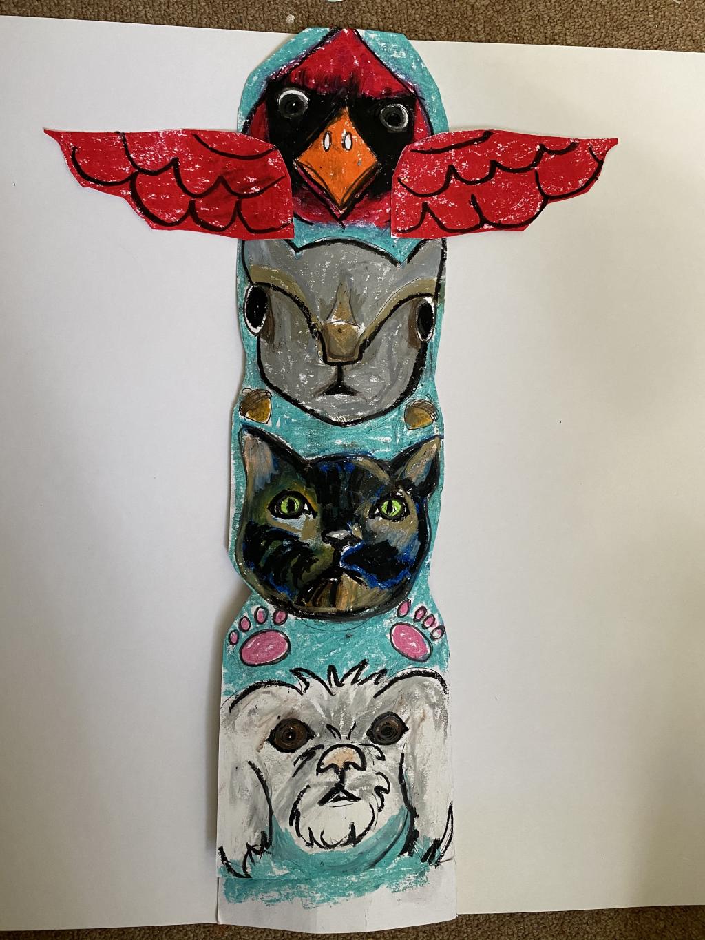 A totem pole drawn on paper featuring a cardinal, a rabbit, a cat and a dog from top to bottom.
