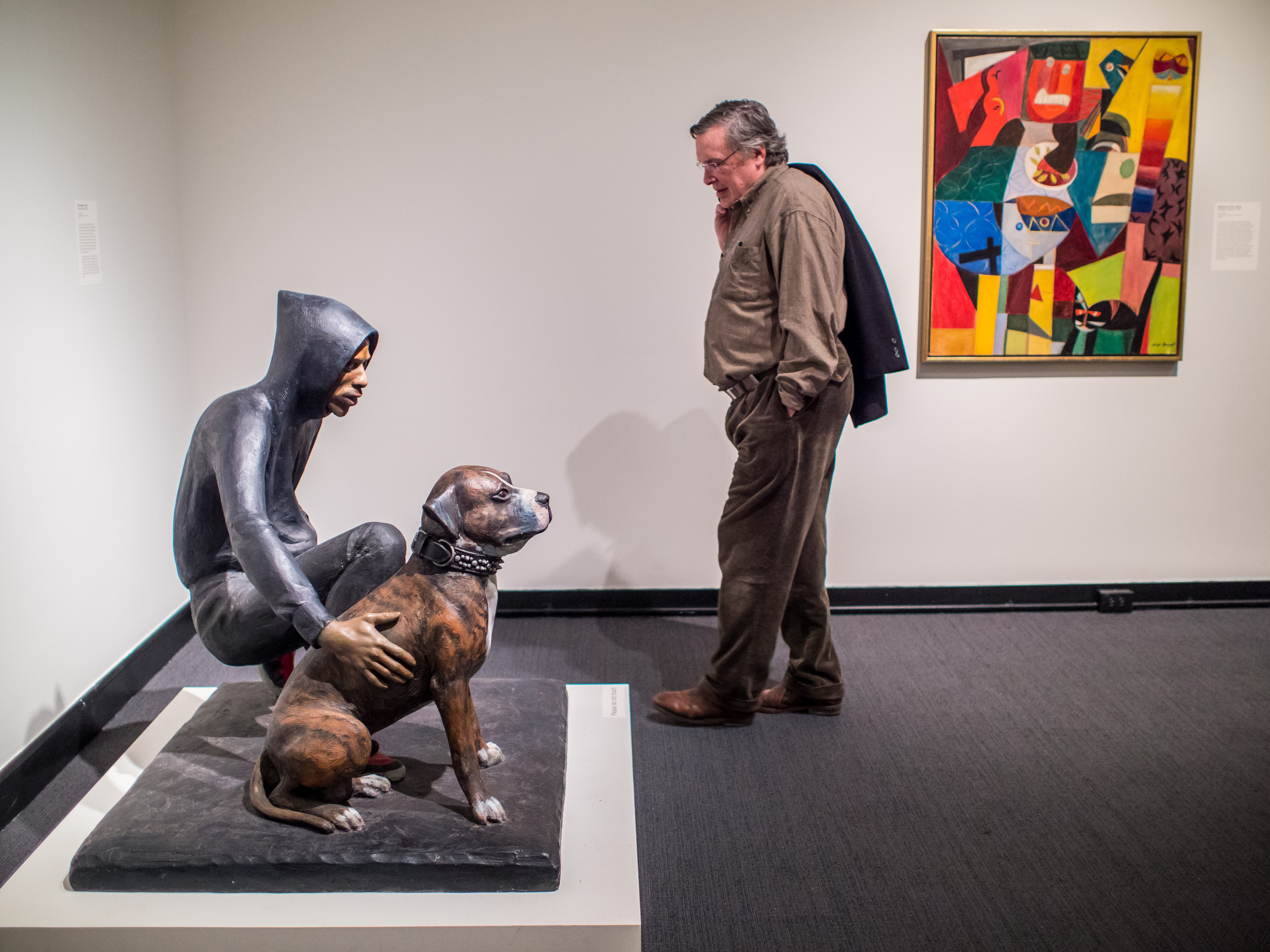Man looking at sculpture