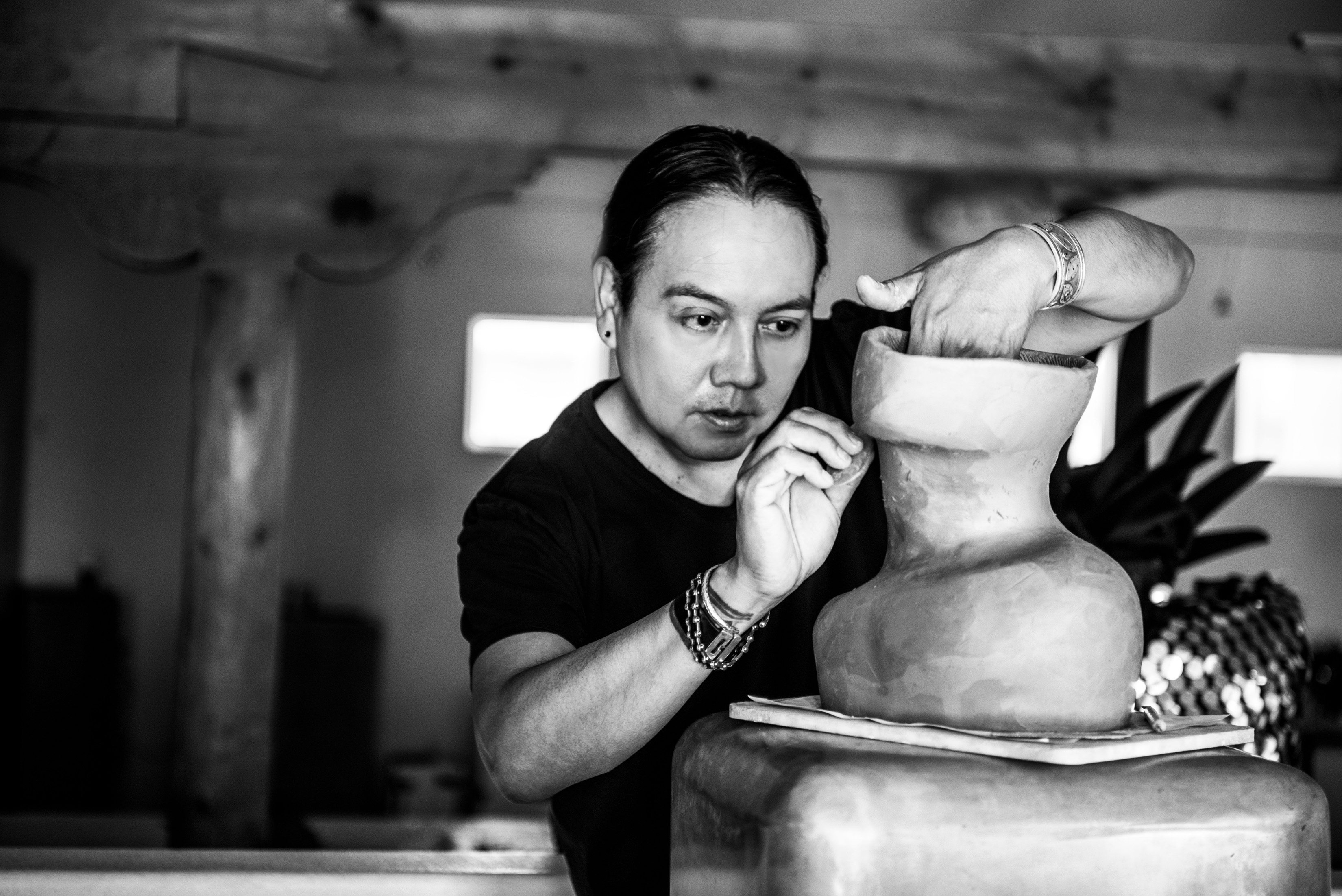 Virgil Ortiz working on sculpting a bust in hist studio.