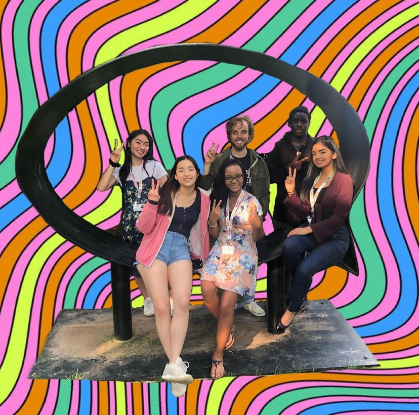 The 2019 teen intern group sitting on a sculpture at MAM with the background photoshopped to be psychedelic rainbow lines.