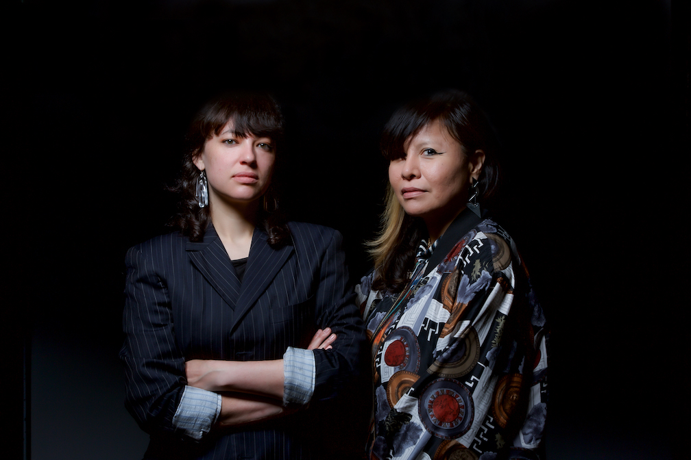 Caroline Monnet and Laura Ortman standing next to each other against a black background.