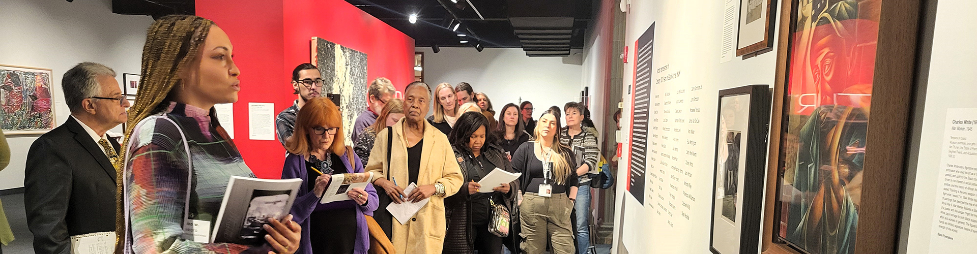 Group of MAM docents on a tour of the exhibition "Century: 100 Years of Black Art at MAM" One of the exhibition's co-curators, nico w. okoro is in the foregraound of the image leading the tour.