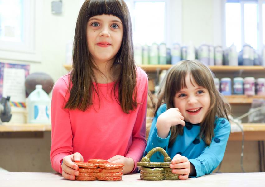 two young girls in a ceramic class