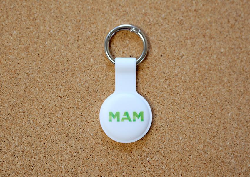 White Apple Air Tag holder with a Green MAM logo