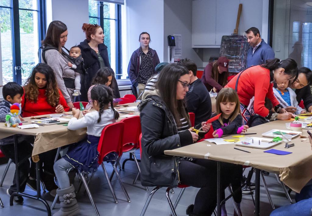 A room full of families work on art projects in the Geyer art studio at MAM.