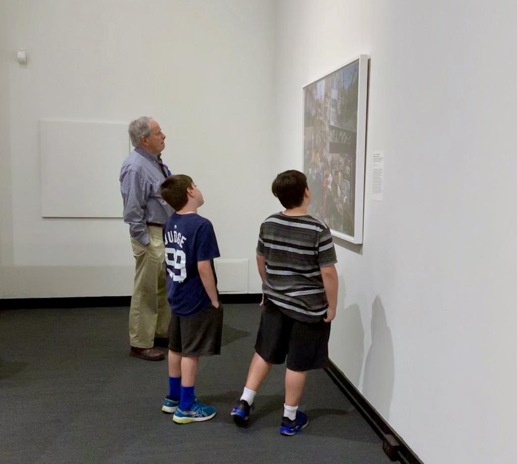 A family in the MAM galleries looking at a painting together.