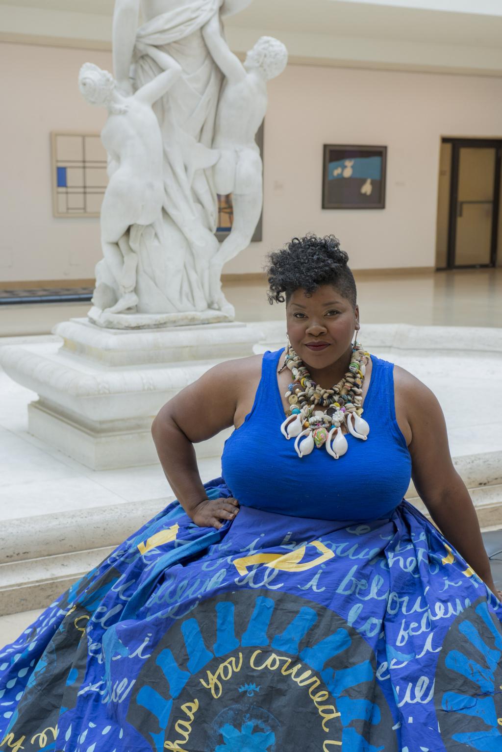 Vanessa German in a gorgeous blue tank dress with full skirt and gold necklace in Avery Court, Wadsworth Atheneum Museum of Art, Hartford, CT, 2016. Photo by Allen Phillips / Wadsworth Atheneum.