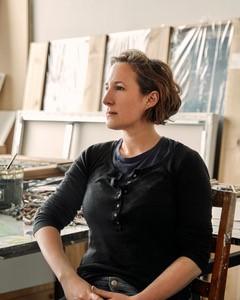 Head shot of natalie frank in her studio. She is seated and looking off to the left.
