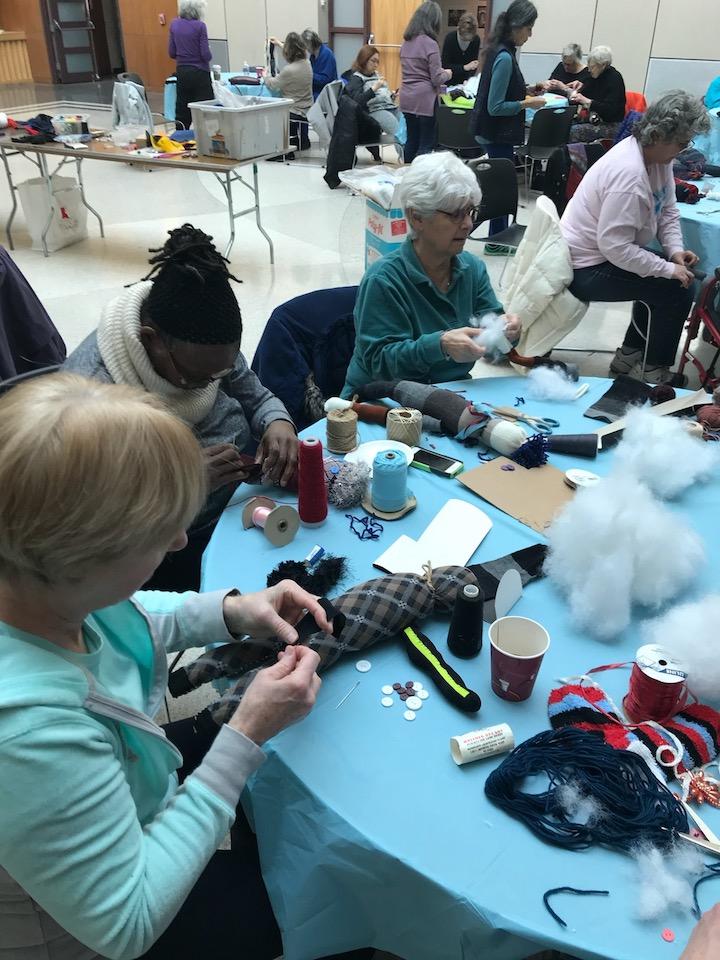 Participants creating plush dolls from found objects.