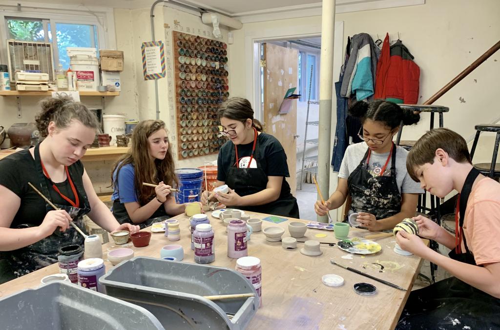 Campers painting their fired ceramics as part of SummerART Ceramics Camp