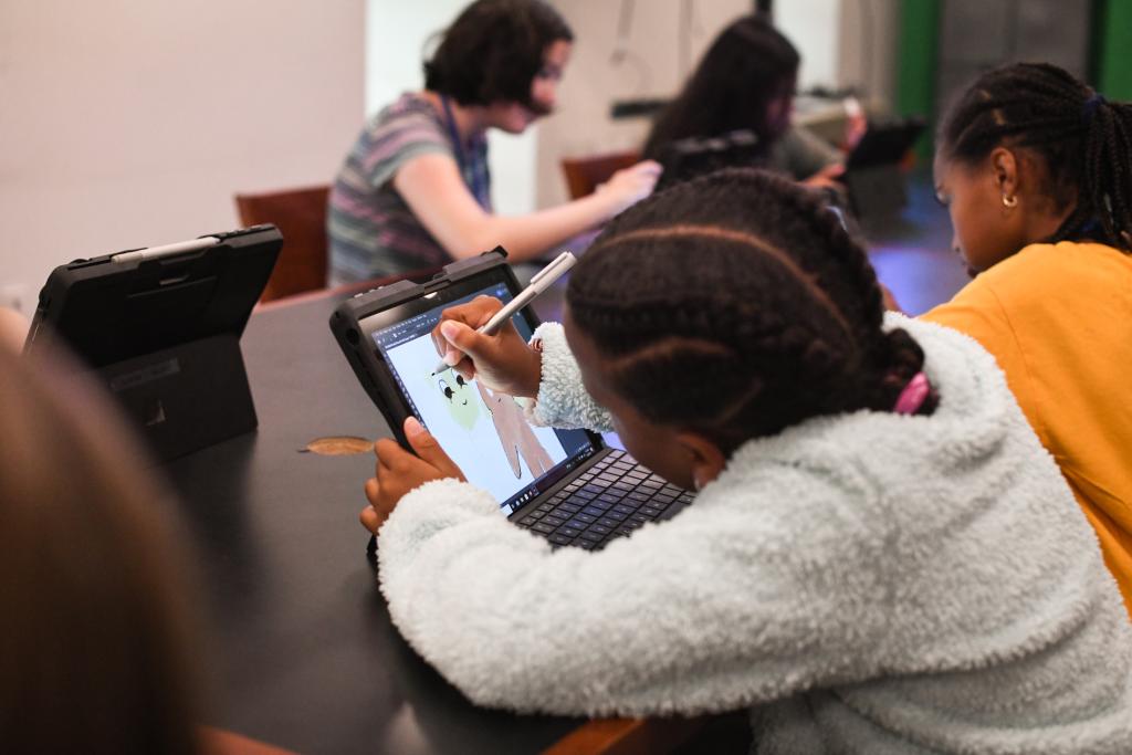 Image of student from the back using a surface pro to draw in the MAM Digital Media Lab.