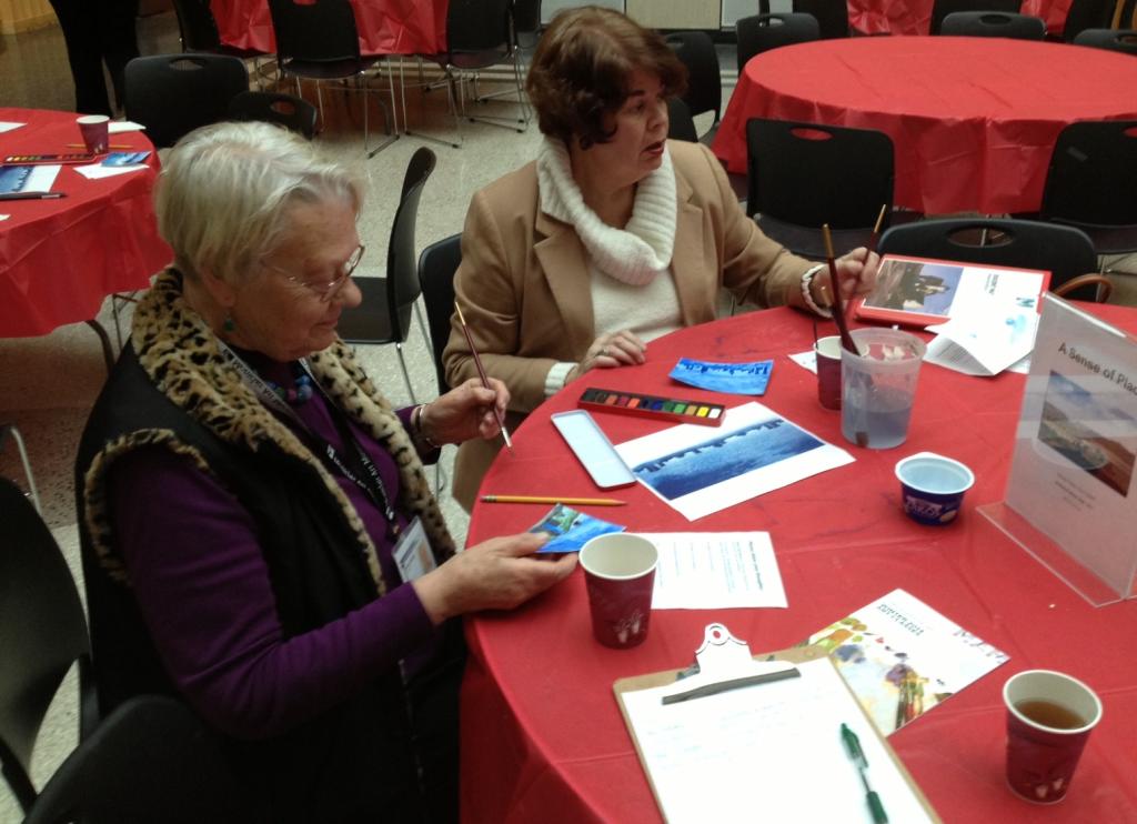 Two women painting at a round table as a part of MAM's Art int he Afternoon program
