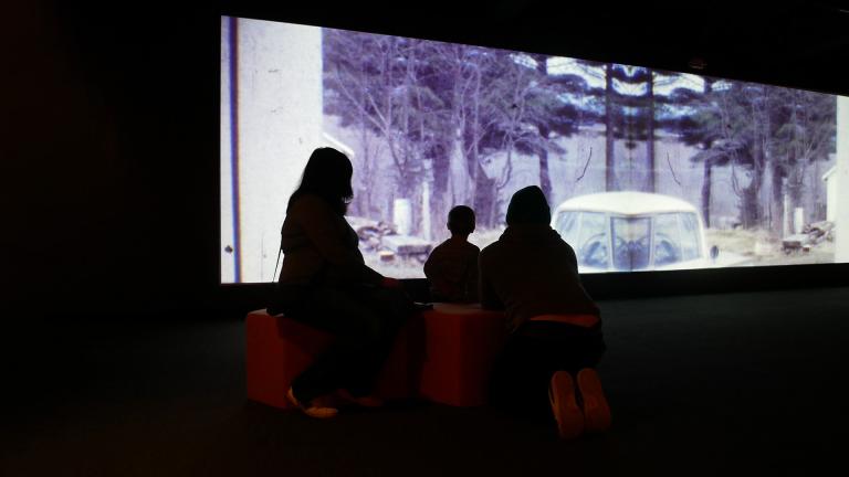 Family in Rand Gallery watching a video installation