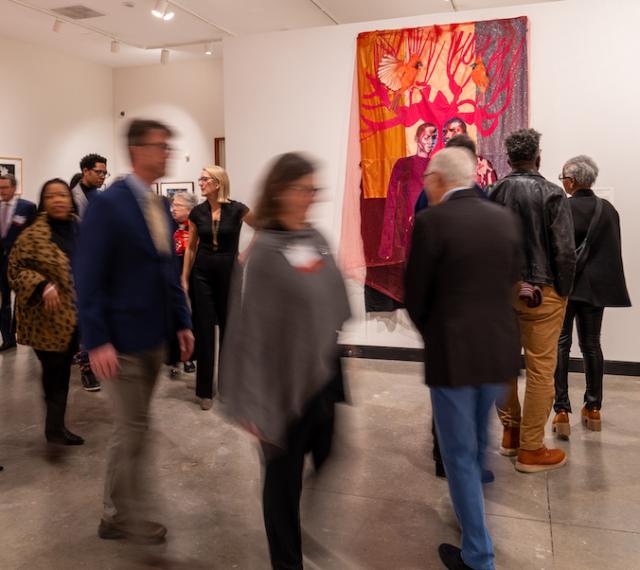 People walking around the exhibition "Century: 100 Years of Black Art at MAM"