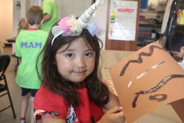 A student is showing her artwork.