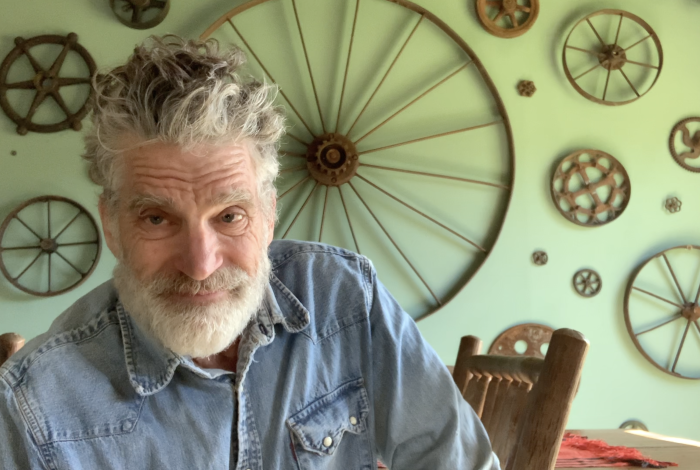 Tom Nussbaum sitting in his home