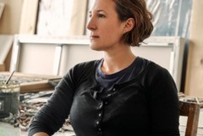 Head shot of natalie frank in her studio. She is seated and looking off to the left.