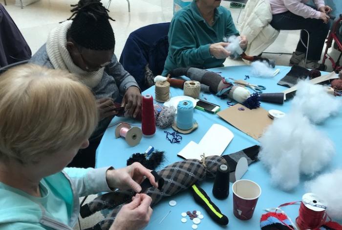 Participants creating plush dolls from found objects.