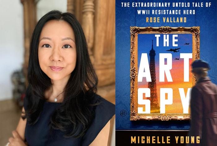 A woman with long dark hair poses next to the book cover of "The Art Spy" featuring a historical WWII theme and the Eiffel Tower.