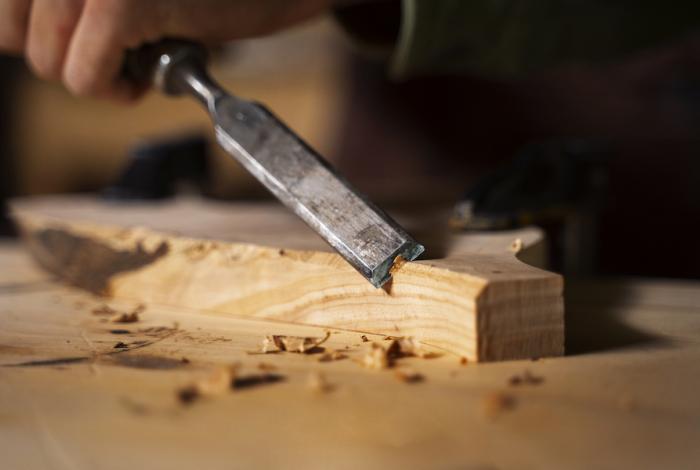 Artisan doing woodcutting side view